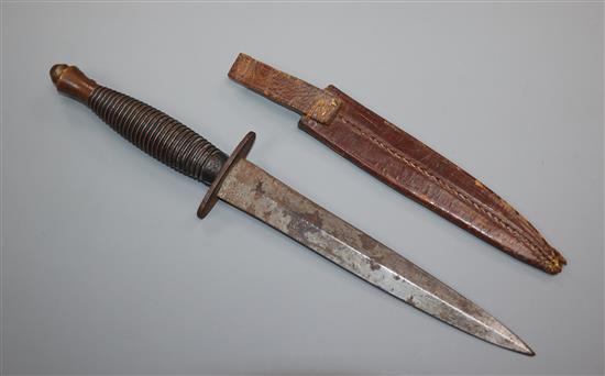 J. Nowill & Sons, A commando fighting knife, ribbed grip and 17cm spear point blade with leather scabbard